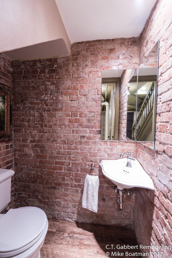 exposed brick in updated bathroom