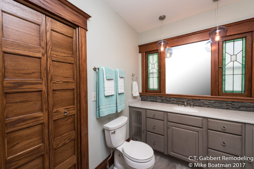 wood cabinets with a light greige vanity in remodeled bathroom