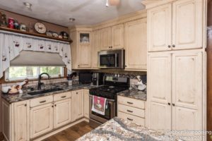 solid oak cabinets in creamy linen with wood floors in kitchen