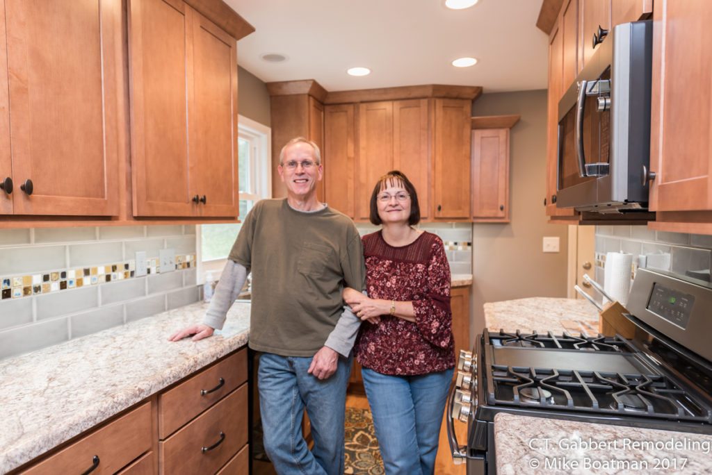 satisfied customers in their new kitchen remodel