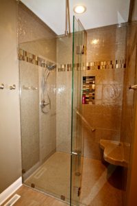 onyx walk in shower with clear shower door and shower seat