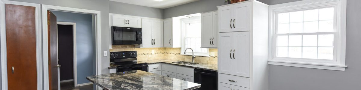 quartz countertop island with floor to ceiling cabinets in white