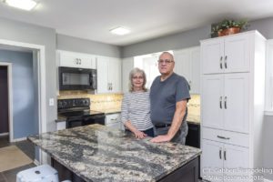 happy customers in their newly remodeled kitchen and bathroom