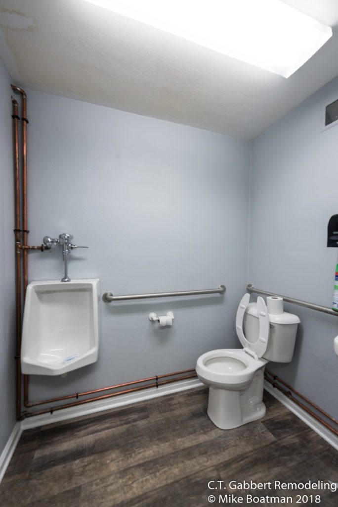 remodeled mens bathroom with blue gray walls