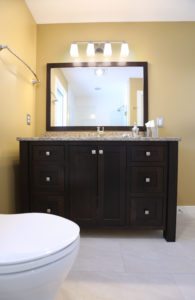 solid wood vanity in golden bright bathroom remodel
