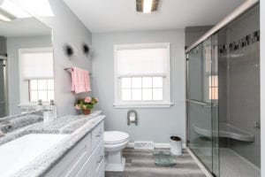wite and grey bathroom remodel with cambria quartz counter and vinyl flooring
