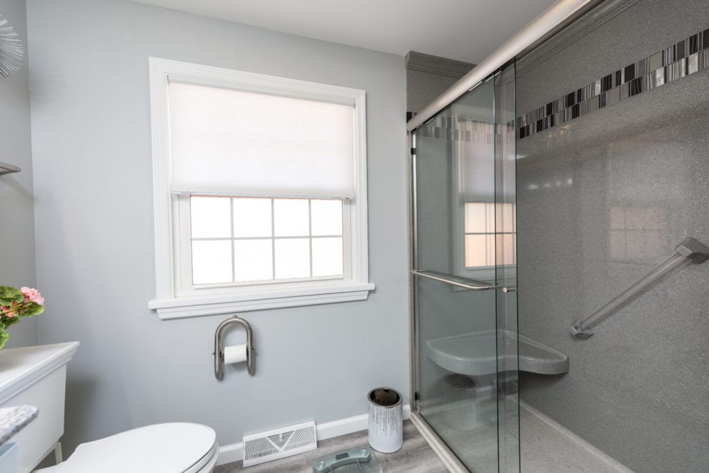 bathroom remodel with glass shower and shower bench