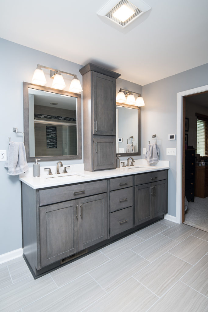 grey vanity with his and her sinks in remodeled bathroom