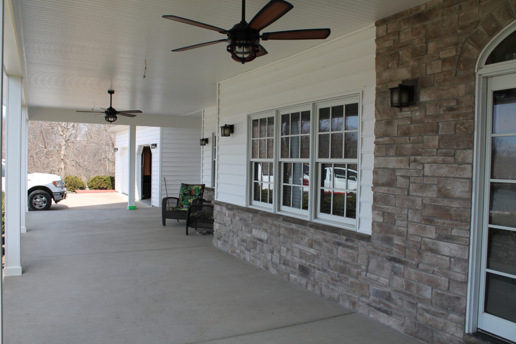 porch with neutral stone work and contrasting white paint