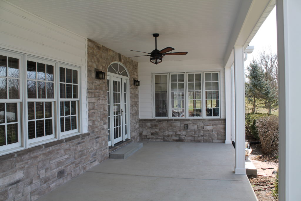 stone work wrapping around door frame of porch